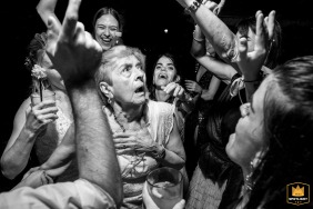 In Perez, Santa Fe, a black-and-white action shot captures the bride's grandmother dancing among the guests.